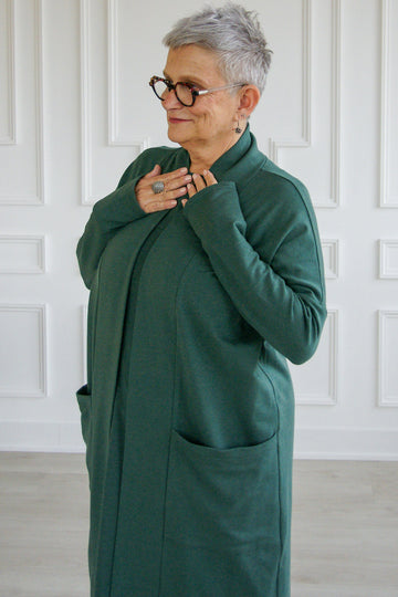 Woman wearing long sleeve pine green tencel open front Courtney cardigan. 