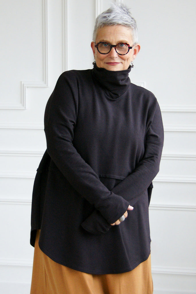 Woman wearing black oversized turtleneck tencel Abigail top by Advika. 