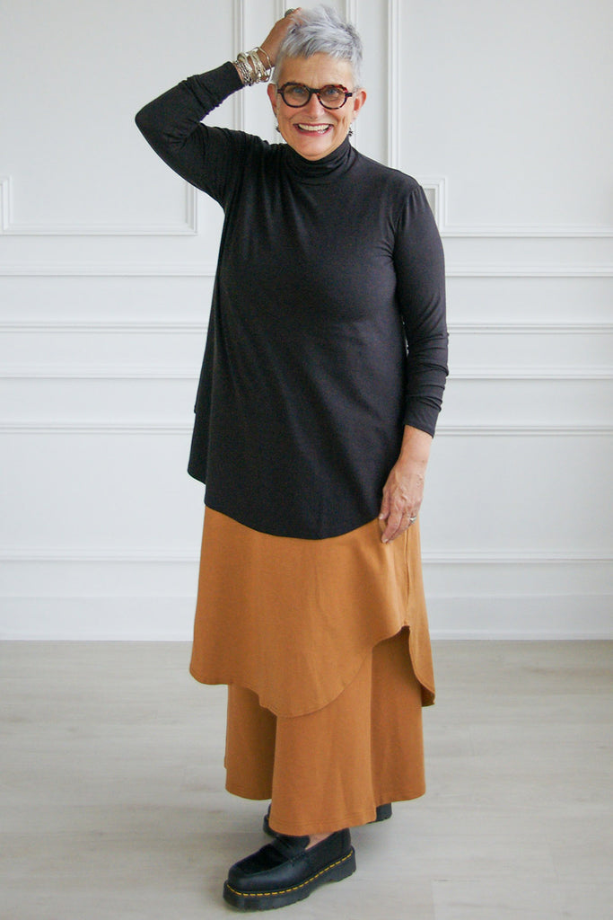 Woman wearing black tencel long sleeve flowy mock neck Lauren top by Advika. 