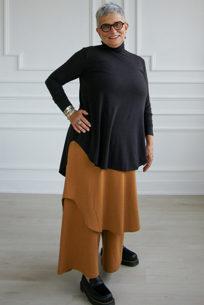 Woman wearing black tencel long sleeve flowy mock neck Lauren top by Advika. 