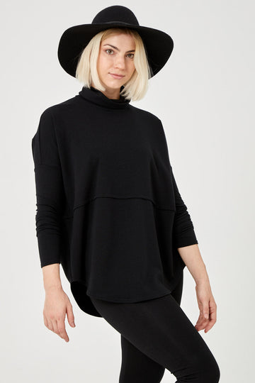 Woman wearing Tencel oversized turtleneck in black, Canadian made women's loungewear, front